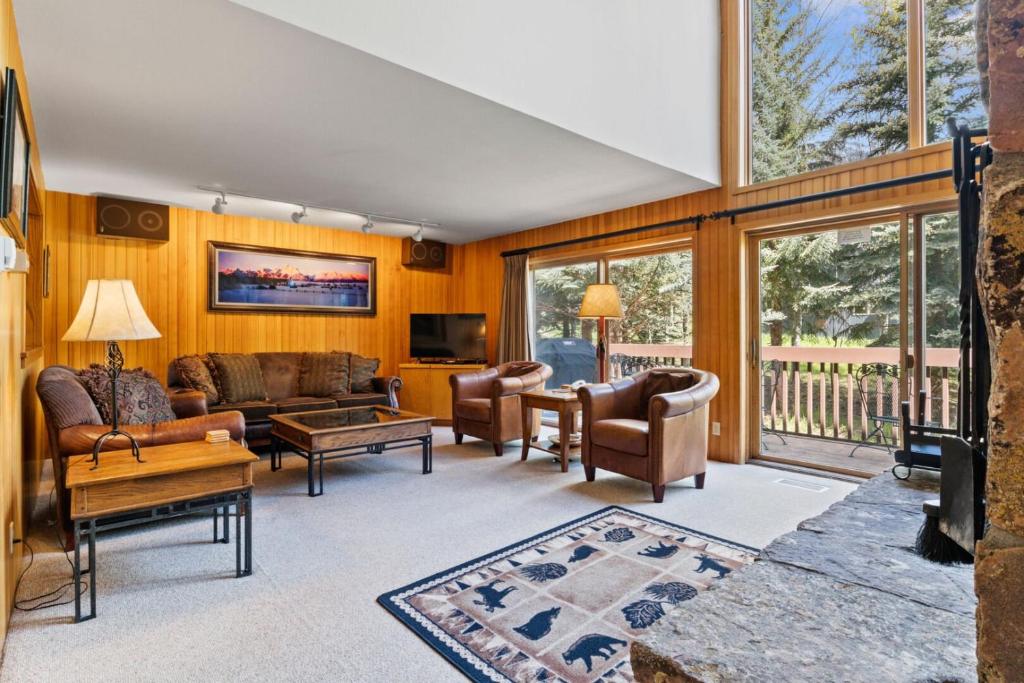 a living room with a couch and chairs and a tv at RMR: Wind River 4 Condo in Teton Village in Teton Village