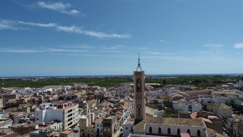 an aerial view of a city with a clock tower at Habitacion en Casa compartida in Bellreguart