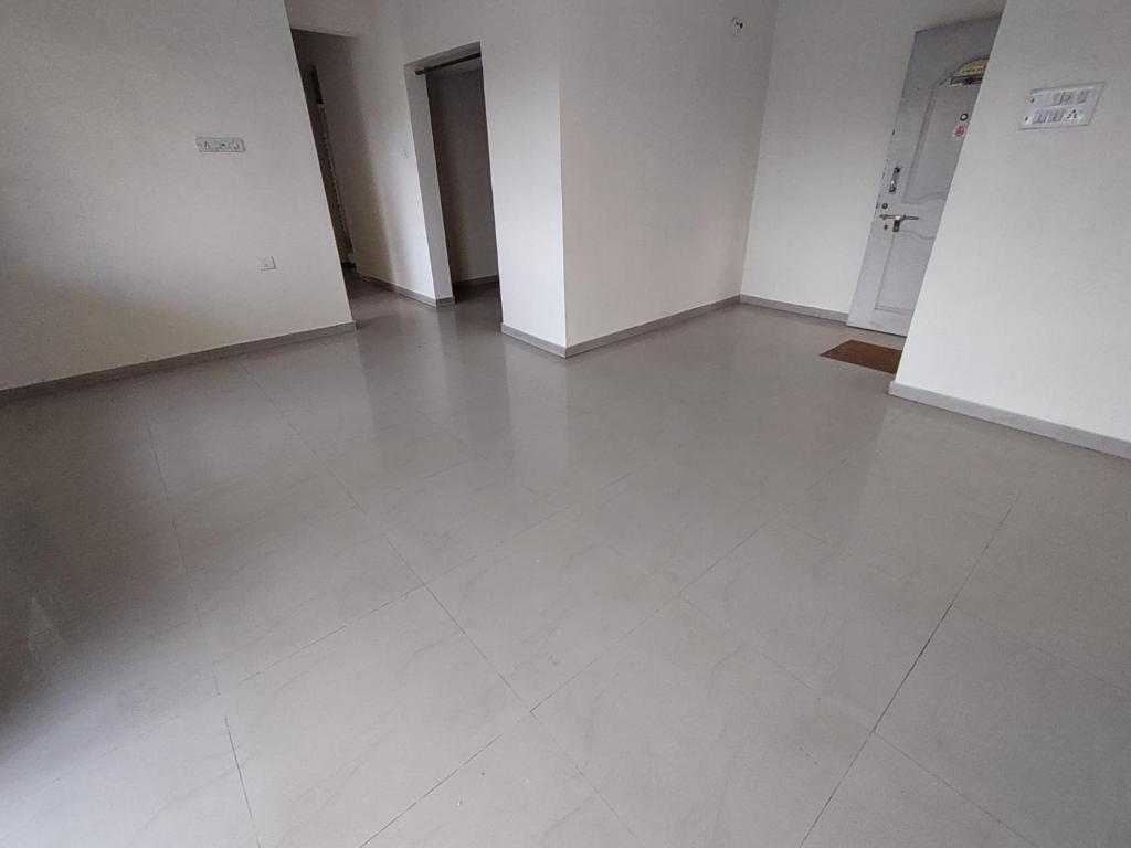 an empty room with white floors and white walls at Professional and Sweet Home in Pune