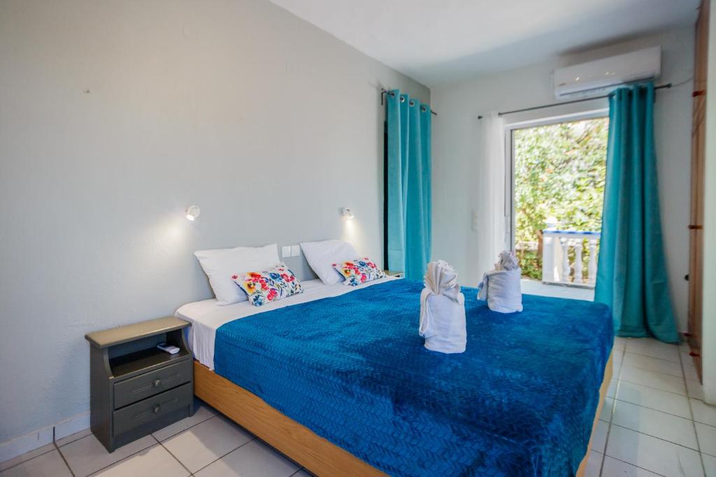 a bedroom with a bed with two babies sitting on it at Velendzas Holidays in Alikanas