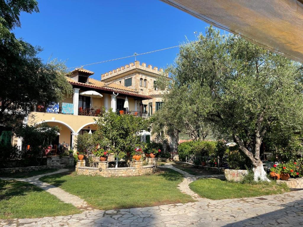 a large house with a garden in front of it at Castello Bellos studios in Marathias