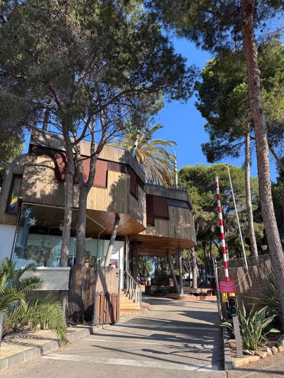 a building with trees in front of a street at Camping Moraira in Moraira