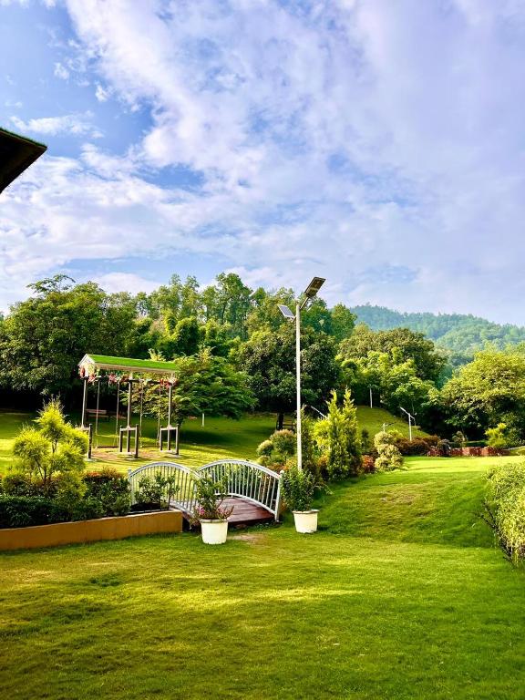 a park with a bridge and a playground at GOOSENECK HOTEL and RESTAURANTS in Kandogal