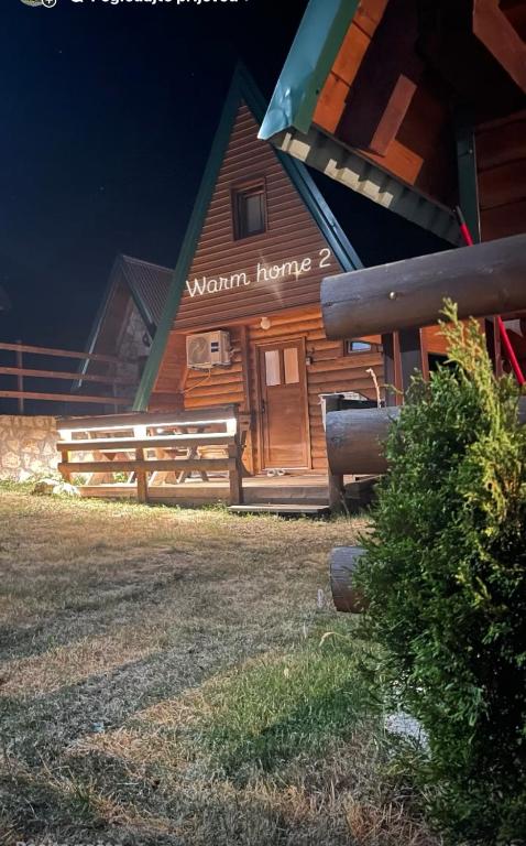 a log cabin with a sign that reads warm home at Warm home 2 Zabljak in Žabljak
