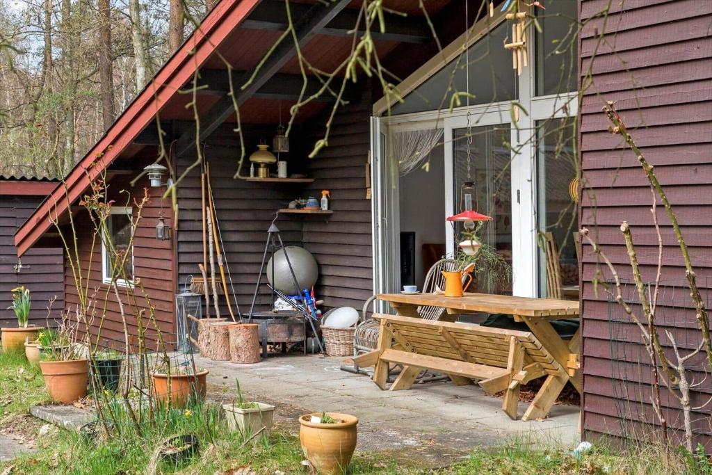 a porch of a house with a wooden picnic table at 2030-Stege-Ulvshalevej-305 in Stege