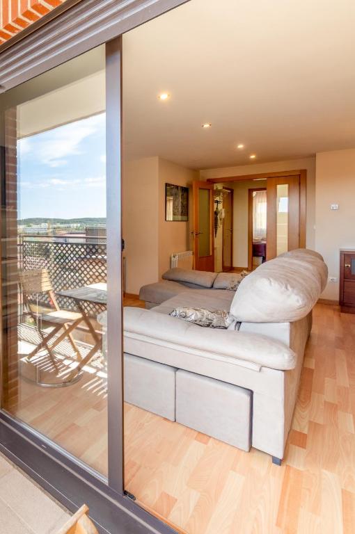a master bedroom with a bed and a balcony at Casa Venerable Carabantes in Soria