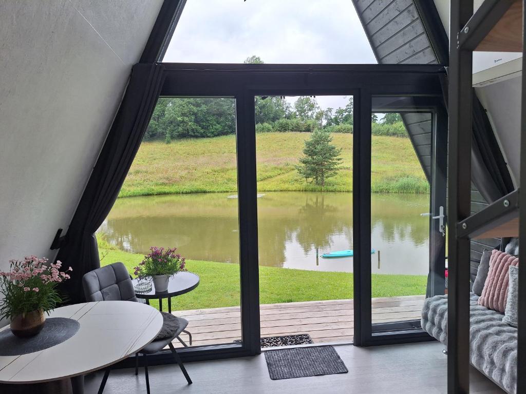 a view of a lake from the living room of a house at Rose Valley Cottage in Ieriķi