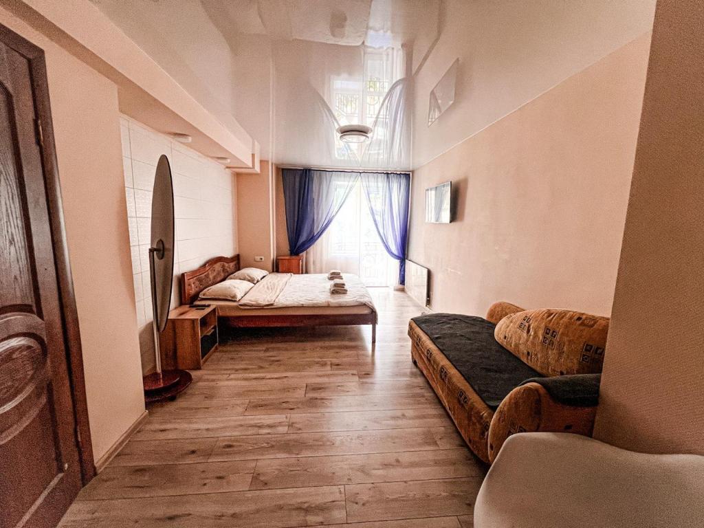 a living room with a couch and a window at Old Town - Andrew descent in Kyiv