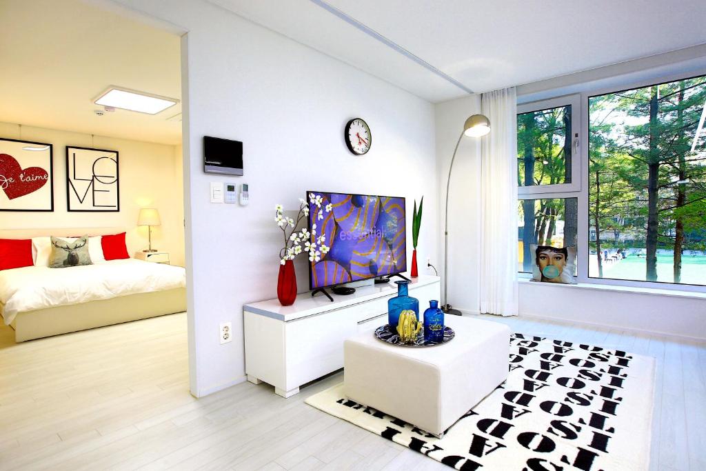 a living room with a tv and a bed in a room at Stay Park 1 in Goyang