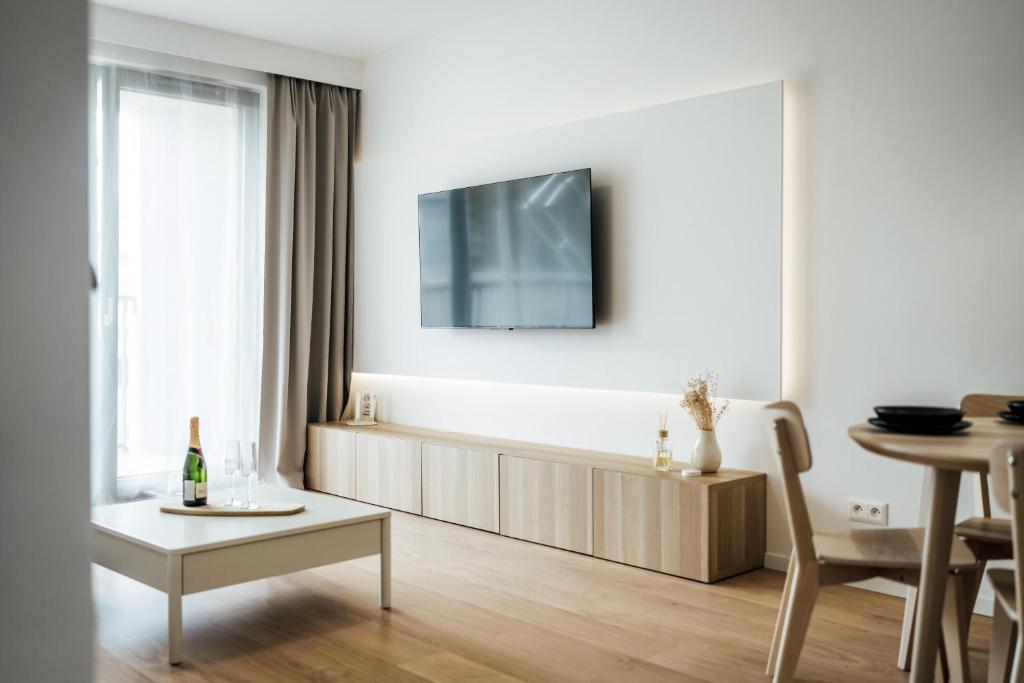 a living room with a tv on a white wall at Severna Residence in Banská Bystrica
