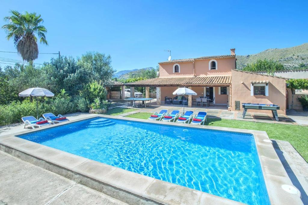 a villa with a swimming pool and a house at Villa Vinya by Villa Plus in El Port