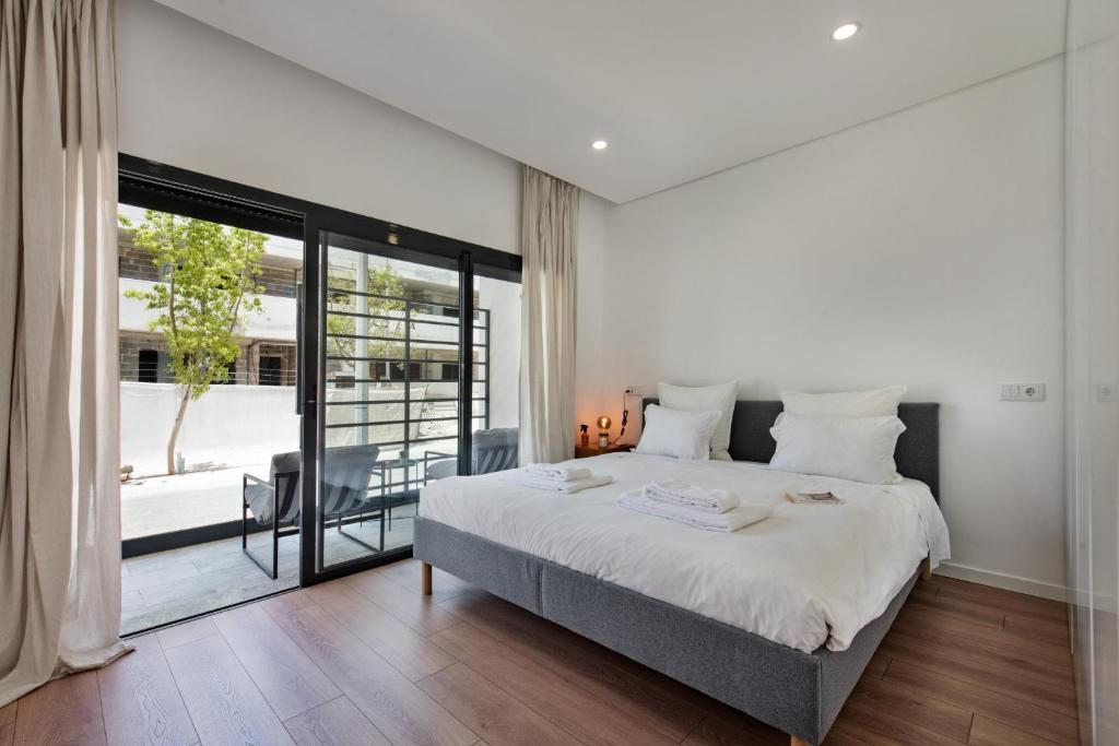 a bedroom with a large bed and a large window at Sunny Apartments in Cabanas de Tavira