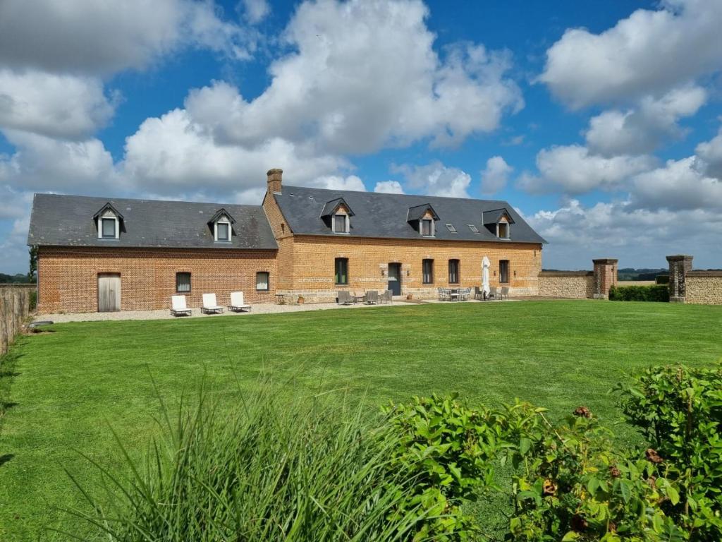 a large brick house with a large yard at Maison Familiale le Maréchal in Doudeville