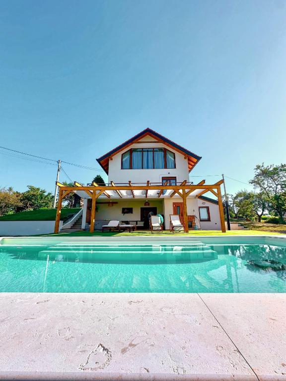 a house with a swimming pool in front of a house at Villa Vukov Breg in Bogdanovec