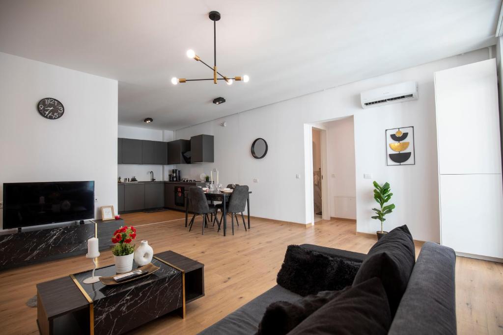 a living room with a couch and a table at Luxe Pearl Towers in Bucharest