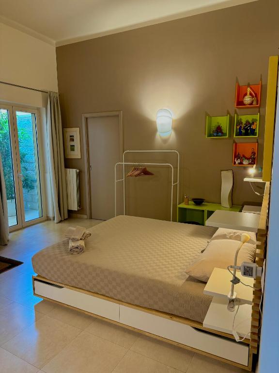 a bedroom with a large bed in a room at Le More Apartment in Rutigliano