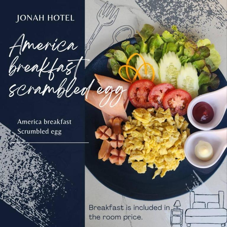 A plated American breakfast with scrambled eggs, salad, sausage and sauces.