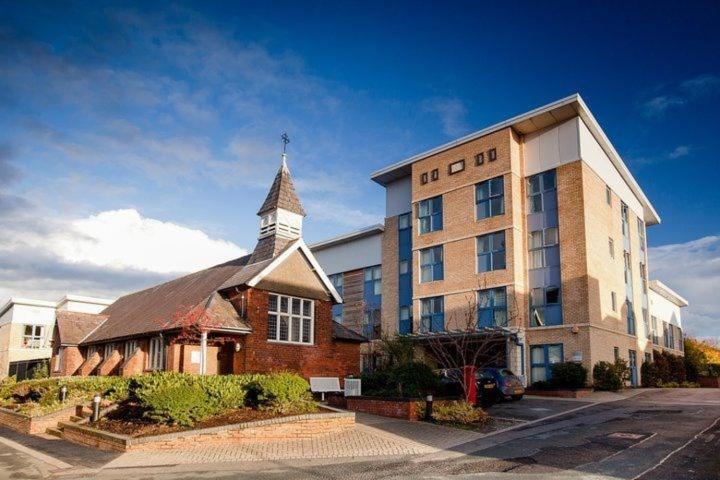 a building with a church with a steeple at Carrock Hall, University of Cumbria Carlisle in Carlisle