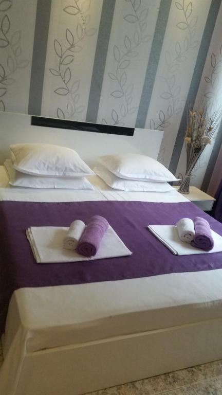 a bedroom with two beds with towels on them at Guest House Dani in Pomorie