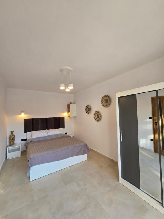 a bedroom with a bed and a glass door at Villa & Apartament Armonia 3 Gaia Flora GRECJA KRETA in Vamos