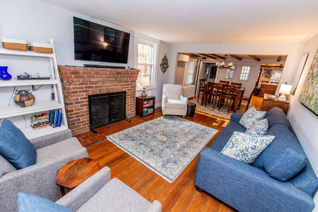 a living room with two couches and a fireplace at Historic Downtown Annapolis Gem Near USNA in Annapolis