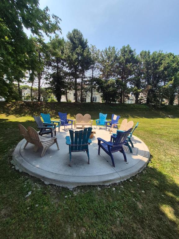a group of chairs and tables in a park at Lake Point Motel in Marblehead
