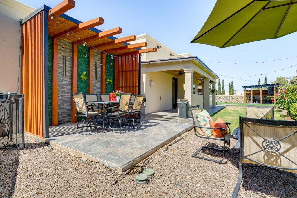 a patio with a table and chairs and an umbrella at Family-Friendly El Paso Home Hike, Shop and Explore in Santa Teresa