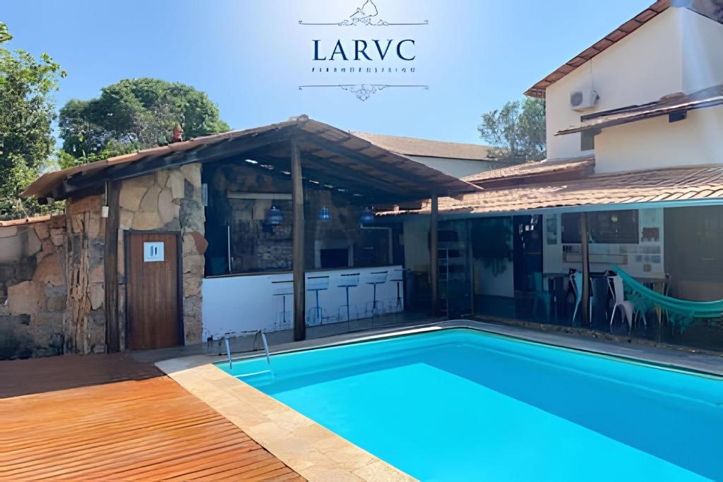 a swimming pool in front of a house at Casa LARVC no coração de Pirenópolis! in Pirenópolis