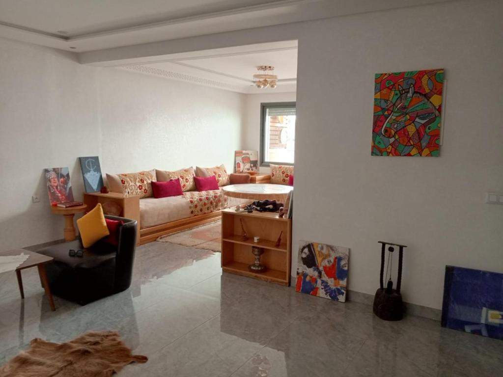 a living room with a couch and a table at Golden Horn Apartment in Agadir