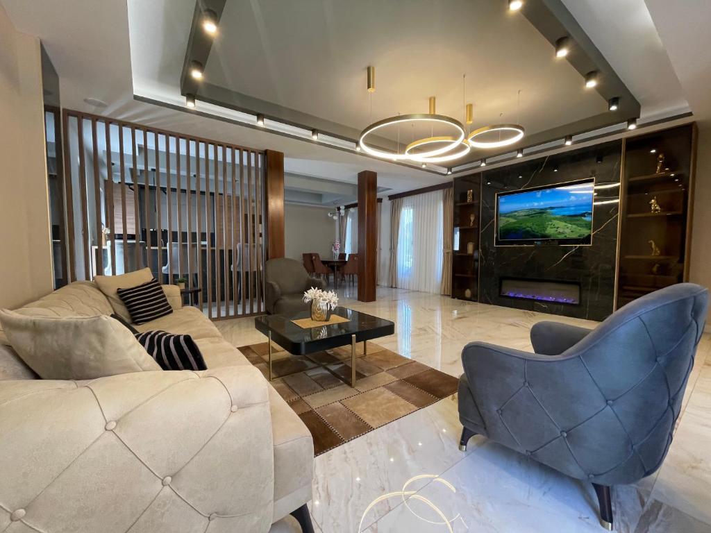 a living room with a couch and a tv at VILA VIKTORIJA in Kolašin