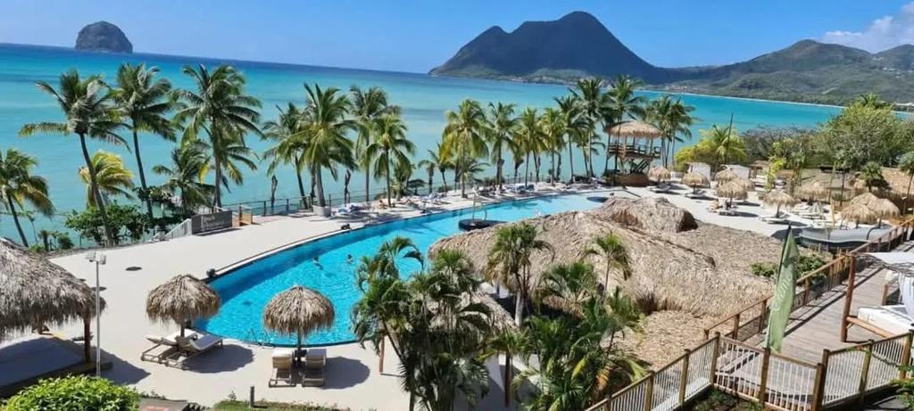 a view of the pool at the resort at Appartement avec piscine au Diamant, 23 m² in Le Diamant