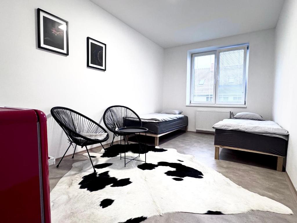a room with two beds and a cow rug at Rybka living apartments in Přerov