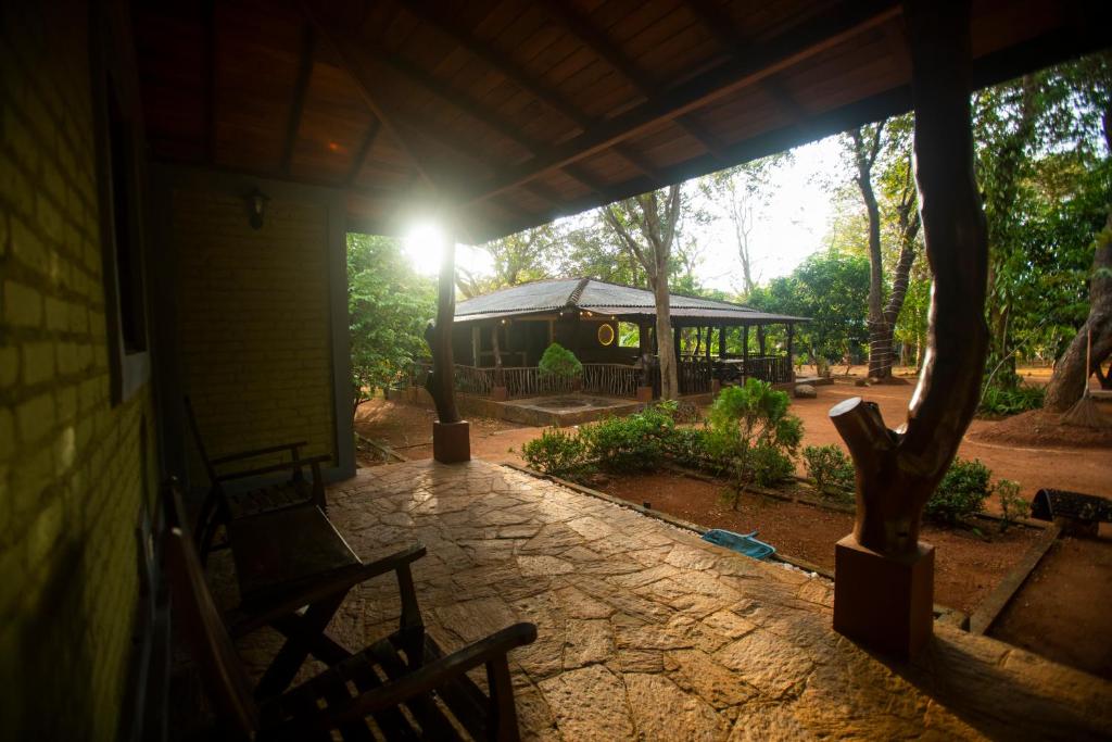 a porch of a house with a pavilion in the background at Funk Bunks - Sigiriya in Sigiriya