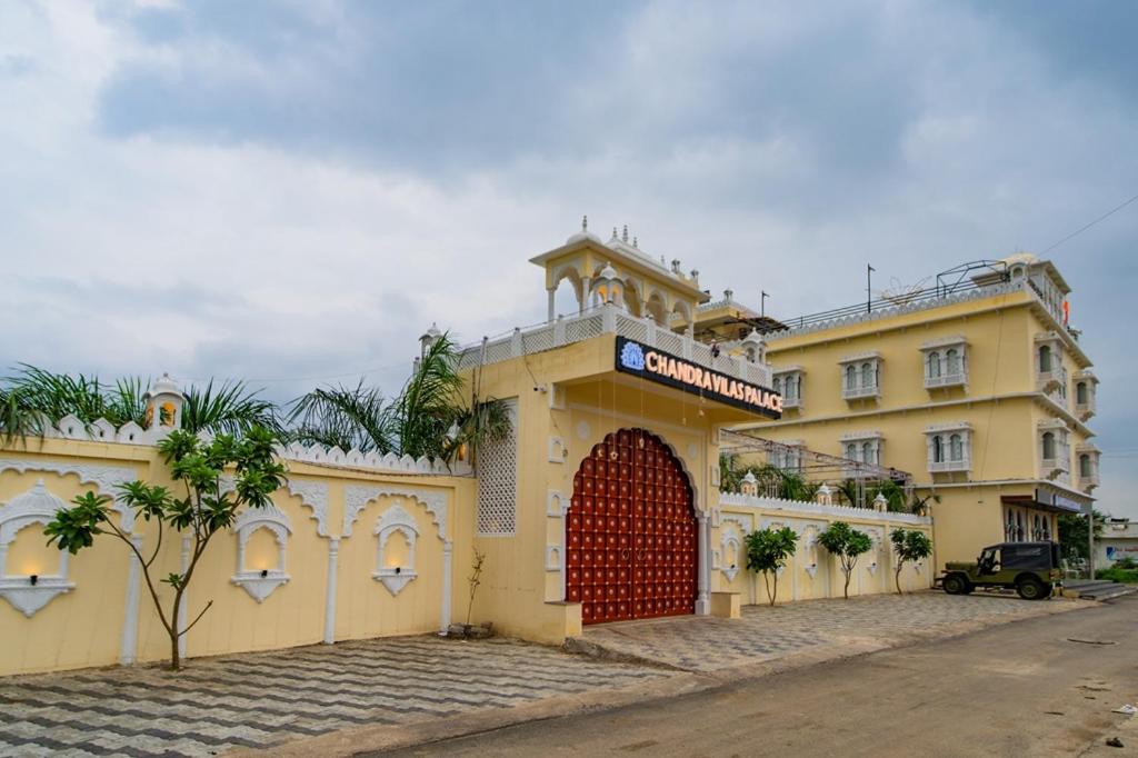 a large yellow building with a red door at Hotel Chandravilas Palace in Jhālāwār