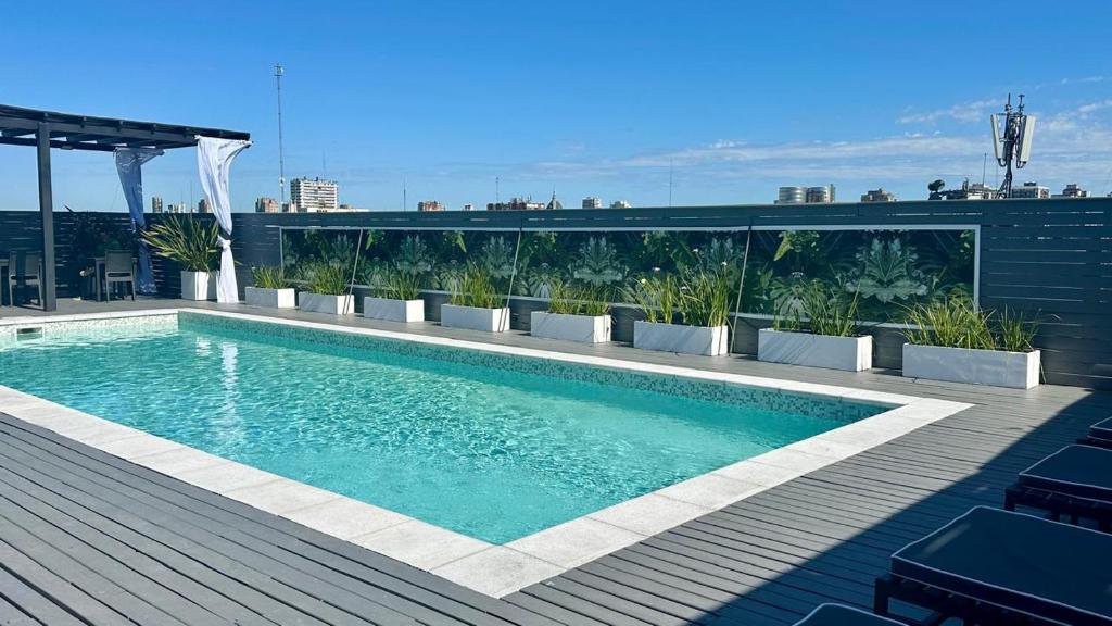 a swimming pool on the roof of a building at Apart by Broadway in Buenos Aires