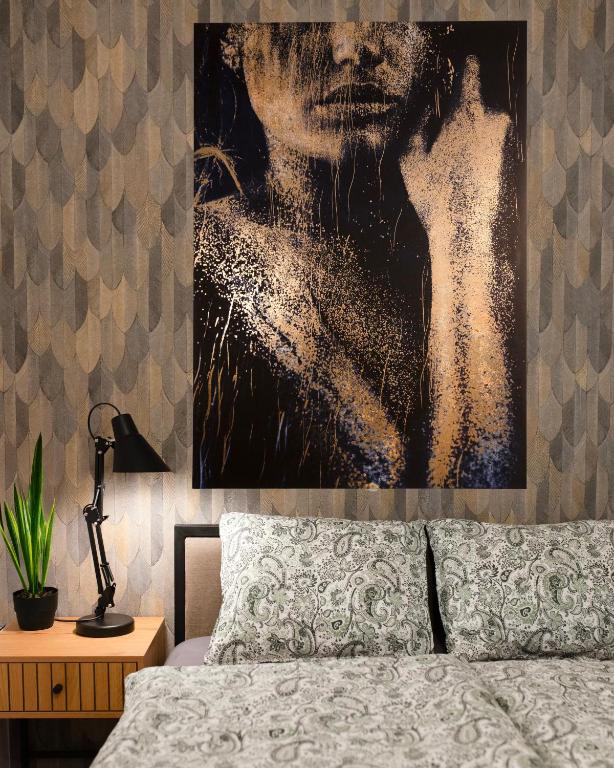 Hotel Heart of Budapest Premium Apartment, CITY CENTER, a painting of a man on a wall above a bed at Heart of Budapest Premium Apartment, CITY CENTER in Budapest