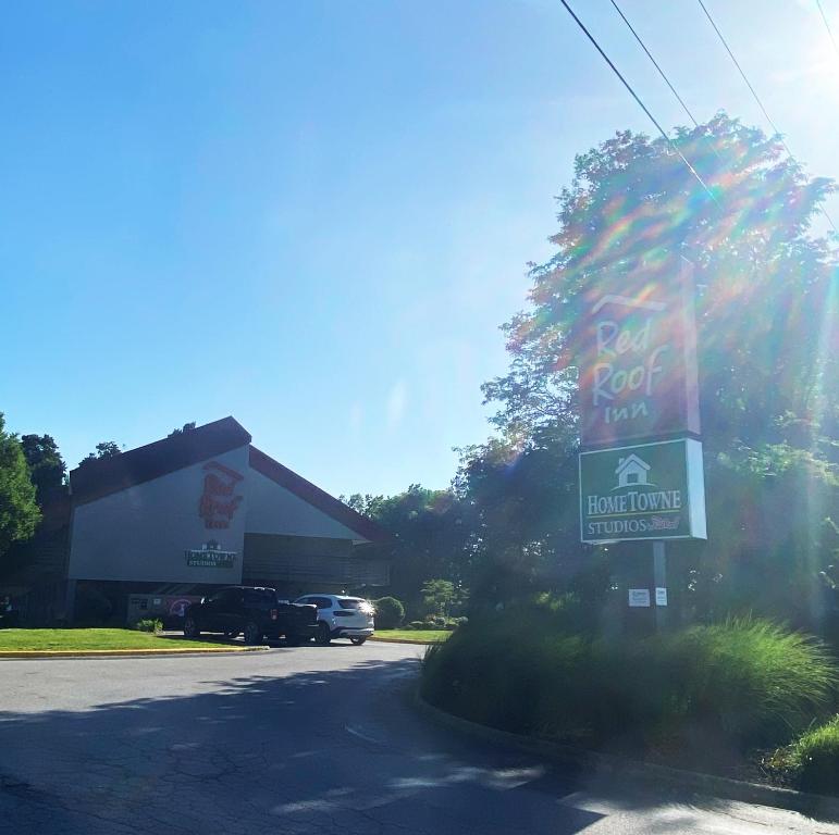 a fast food restaurant with a sign in front of a building at HomeTowne Studios by Red Roof Buffalo - Niagara Airport in Williamsville