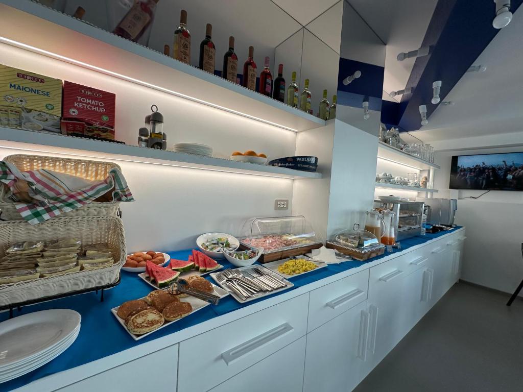 a buffet of food on a counter in a kitchen at B&B Margherita Lido Marini in Lido Marini