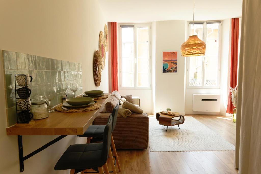 une salle à manger avec une table et une chambre avec une fenêtre dans l'établissement Studio au coeur du Vieux Nice - Vue mer et clocher, à Nice