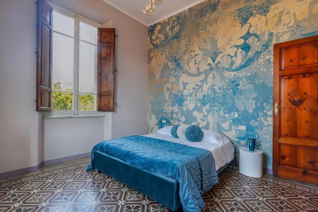 a bedroom with a bed and a wall mural at Appartamento Anita in Lucca