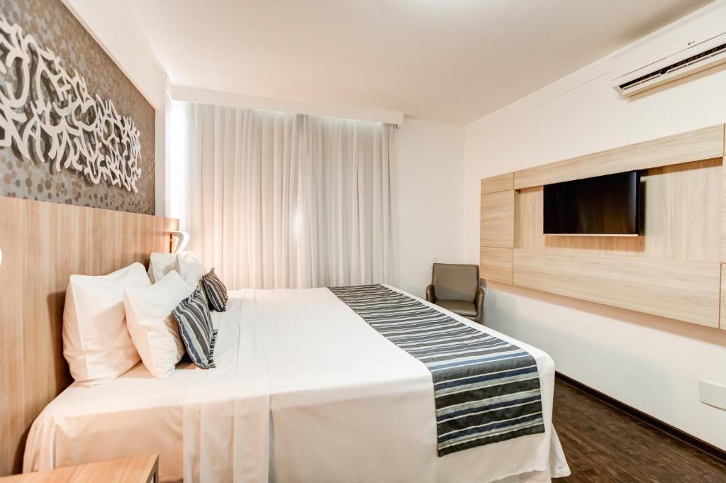 Cama ou camas em um quarto em Allia Gran Pampulha Suites