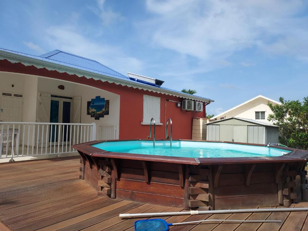 a pool on the deck of a house at Villa Bellevue in Sainte-Rose