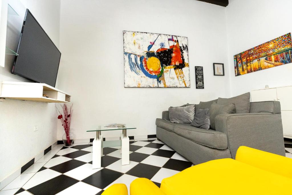 a living room with a couch and a tv at Old San Juan The Core By Otium in San Juan
