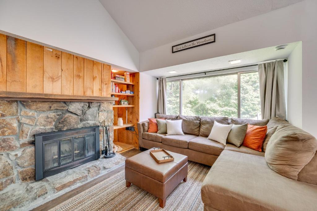 a living room with a couch and a fireplace at Winter Fun! Resort Condo half Mi to Campton Mtn in Campton