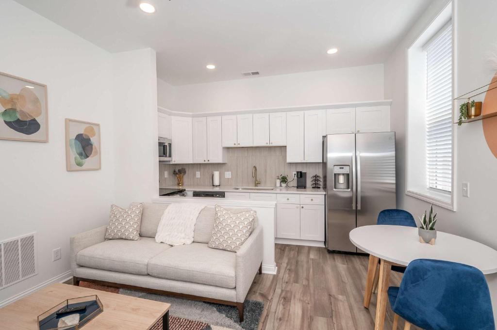 a living room with a couch and a kitchen at Covington Charm 202 in Covington