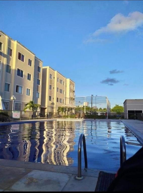 a swimming pool in front of a building at Apto Familiar in Aracaju