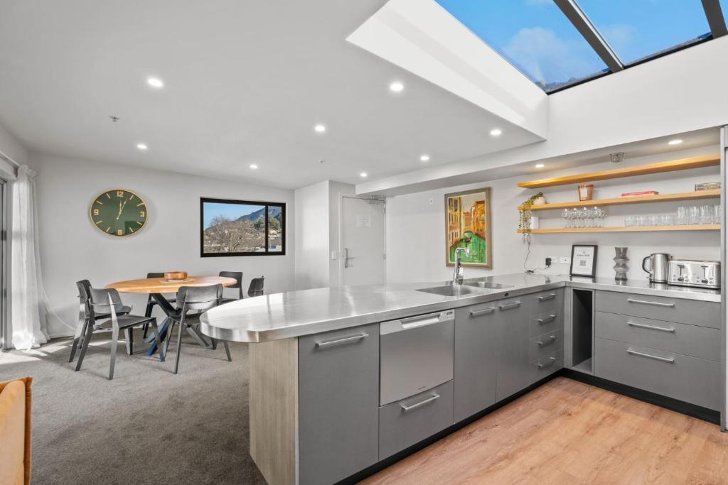 a kitchen and dining room with a table at Cecil Peak View Apartment in Queenstown