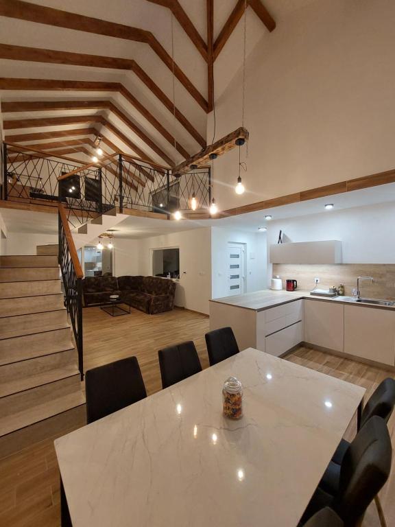 a kitchen and living room with a table and chairs at Villa Marija in Livno