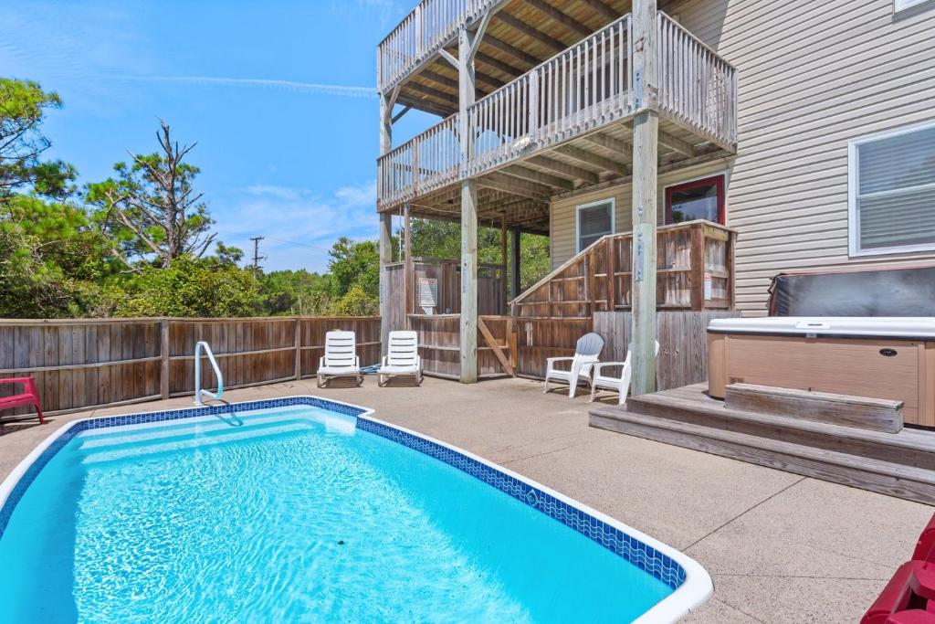 a swimming pool on a patio next to a house at 1702 - Sandpiper Lookout in Poplar Branch