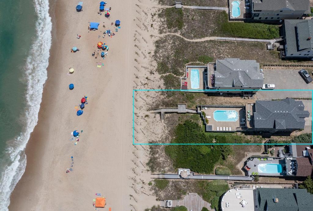 an overhead view of a beach with a group of people at 6067 - Sand Pebble in Nags Head